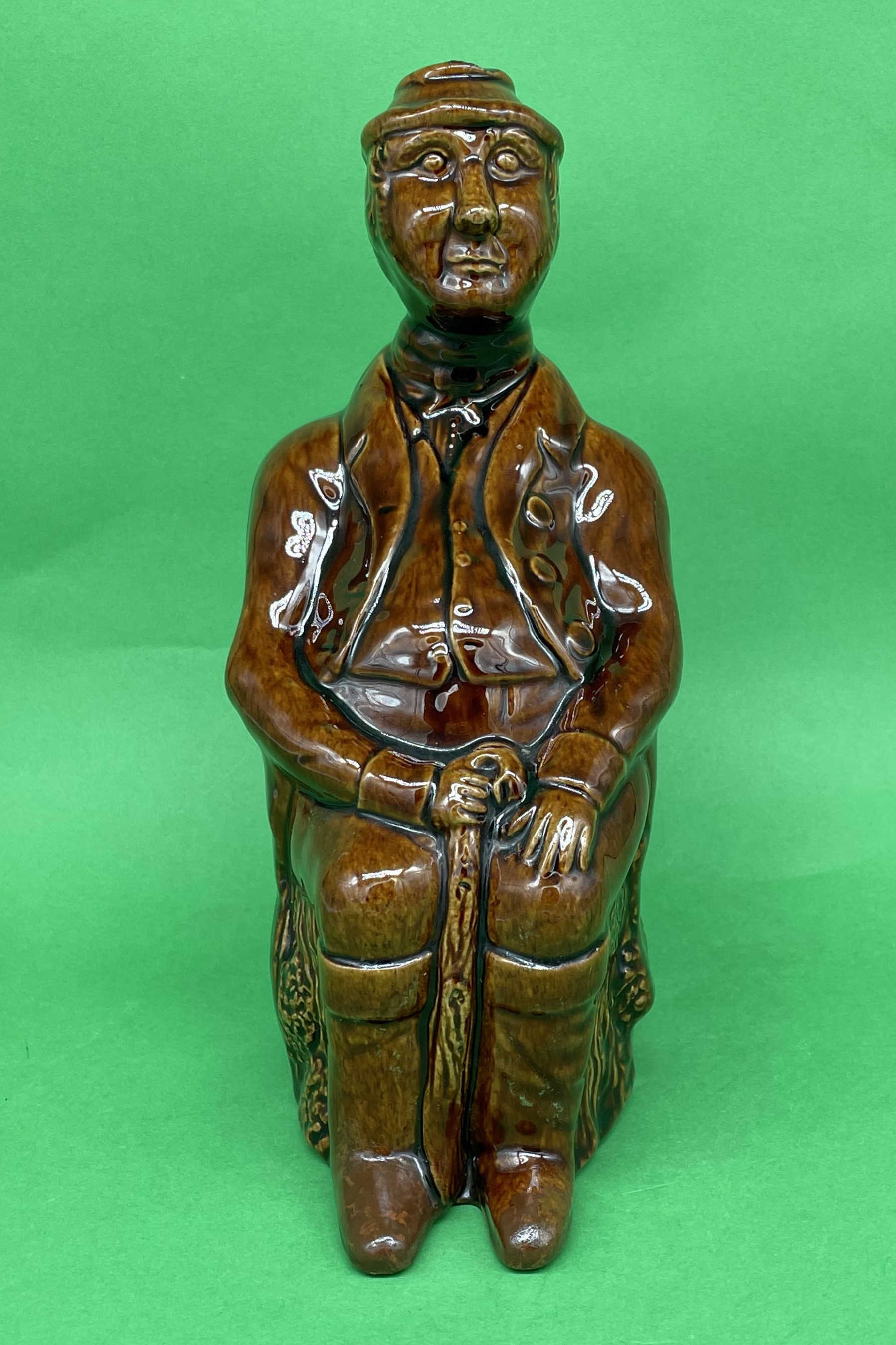 Sitting Man bottle Rockingham Staffordshire circa 1830
